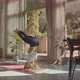Yogui Blond Caucasian Female in a White Sports Bra and Black Leggins Practicing Headstand at Home - VideoHive Item for Sale