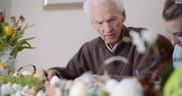 Happy Easter - Grandfather and Granddaughter Writing Easter Cards with Greetings.