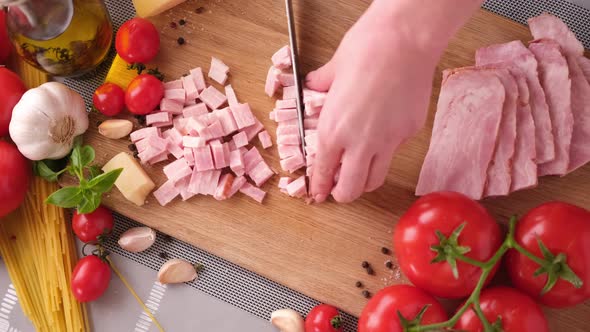 Making Pasta Carbonara Slicing Traditional Pancetta Bacon Into Pieces on a Wooden Cutting Board with