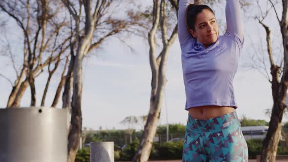 Caucasian woman stretching in a park