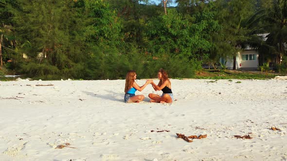 Sexy Beauty Models Traveling Spending Quality Time at The Beach on Clean White Sand and Blue