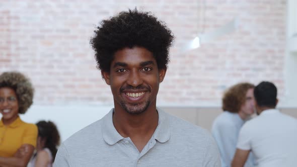 Young Smiling African American Entrepreneur Man Looking at Camera in Office