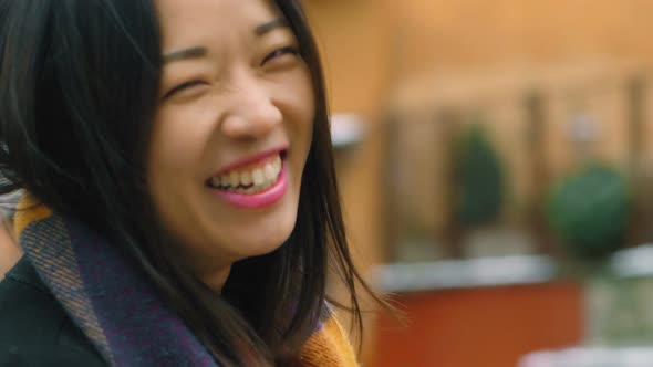 Portrait of beautiful asian woman laughing outdoor- slow motion