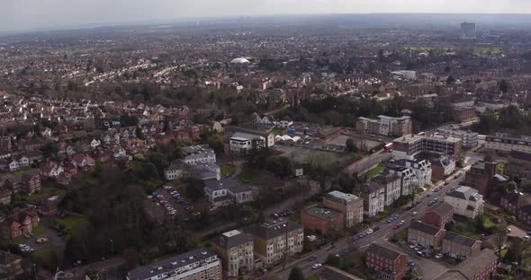 Wide aerial view of Surbiton town on the suburbs of London, UK with a pan up to the horizon.