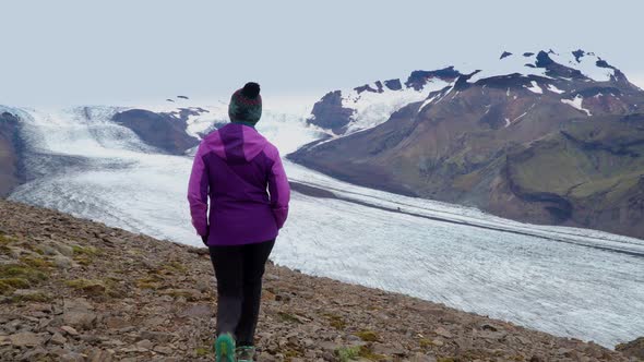 Women Rises on a Mountain Ridge