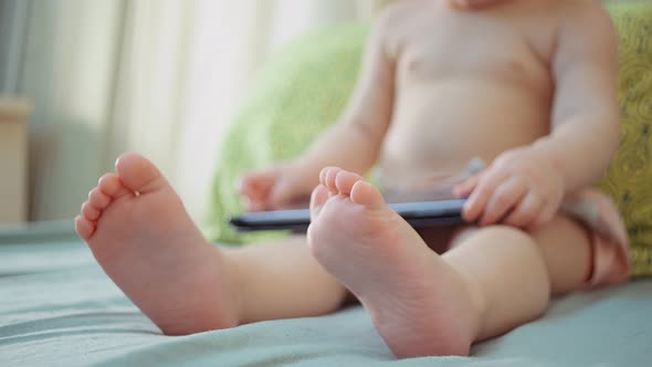 small child and modern technology. sitting child with electronic tablet alt