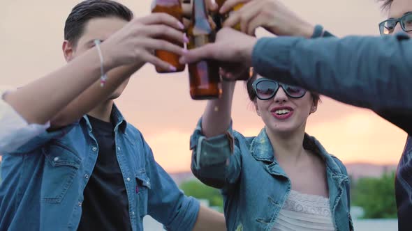 Happy Friends Drinking Beer, Cheering With Bottles And Dancing