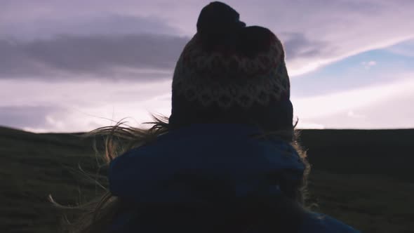 Cinematic Shot of Young Woman Looking at Sunset on Field Slow Motion
