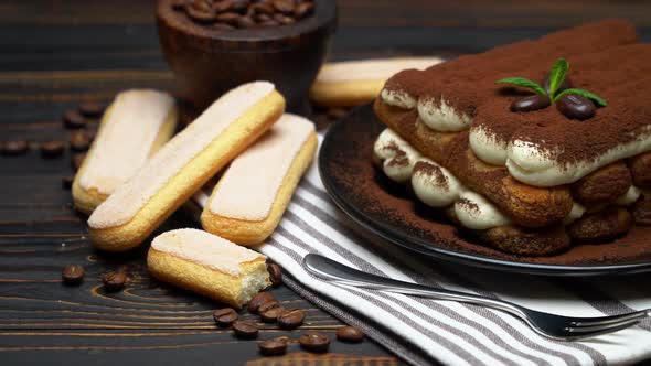 Classic Tiramisu Dessert and Savoiardi Cookies on Ceramic Plate on Wooden Background