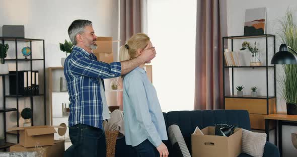 Man Leading His Wife with Closed Eyes and when Opening them Making Surprise in New Apartment