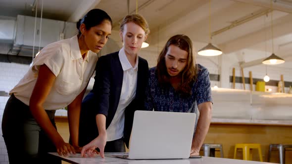 Business executive discussing over laptop