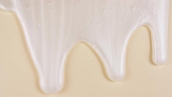 White Cosmetic Gel Fluid Cream With Molecule Bubbles Flowing On The Plain Beige Surface