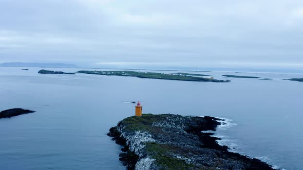 Klofningur Lighthouse In The Small Island Near Flatey Island, Iceland. Aerial Pullback