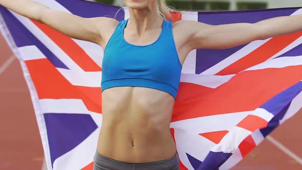 Smiling Gymnast Celebrating Victory and Holding Flag of Great Britain, Pride