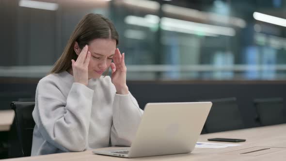 Woman with Headache Working on Laptop