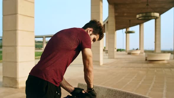 Attractive tall man in sportswear prepare to run while using his smart watch, shot in slow motion wi