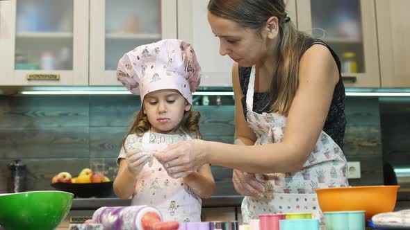 Mother making cookies with her daughter