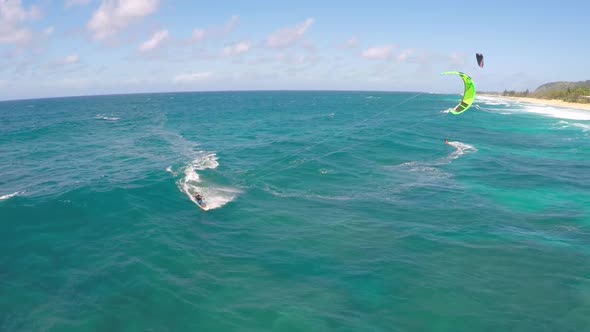 Aerial view of a man kitesurfing in Hawaii.