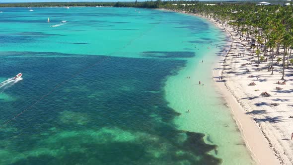 Tropical Coastline with Resorts Palm Trees and Caribbean Sea with Floating Boats and People Having