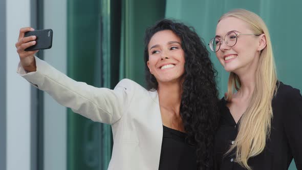 Smiling Modern Diverse Businesswomen Using Smartphone Taking Selfies Outdoors