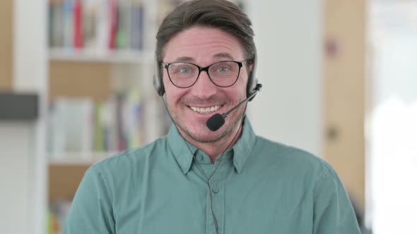 Middle Aged Man with Headset Smiling at the Camera