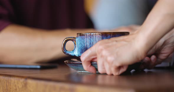 Man's Hands Typing on Grey Laptop While Sitting in a Cafe