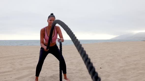 Mixed ethnicity woman exercising at the beach