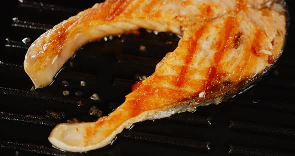 Fresh Salmon Steak Is Fried in a Frying Pan in Oil. 