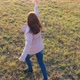 The Girl Runs Across the Field Holding a Plane Simulates Flight - VideoHive Item for Sale