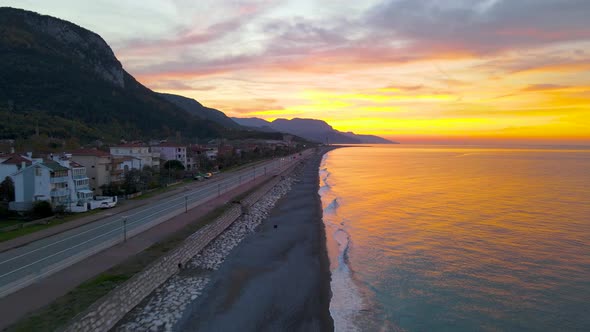 sunset on the beach in autumn, drone on the calm sea