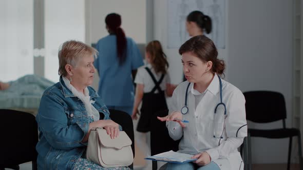 Close Up of Senior Woman and Doctor Talking About Diagnosis