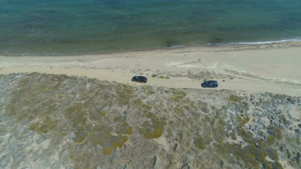 Aerial View of Two Cars Driving at Shore Line in Lemnos, Greece