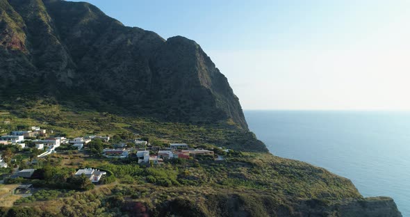 Panoramic and Picturesque Rocky Coastline During Sunset with Green Fields Trees and Small Village