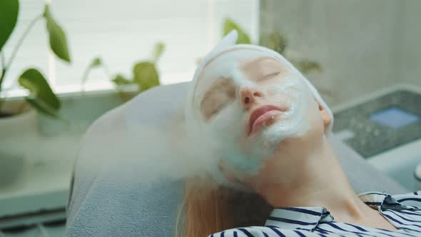 Medium Close-up Shot of Professional Facial Skin Care Treatment with a Cosmetic Steamer at Beauty