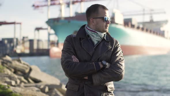 Portrait of Handsome Man in the Harbor at Cold Sunny Day