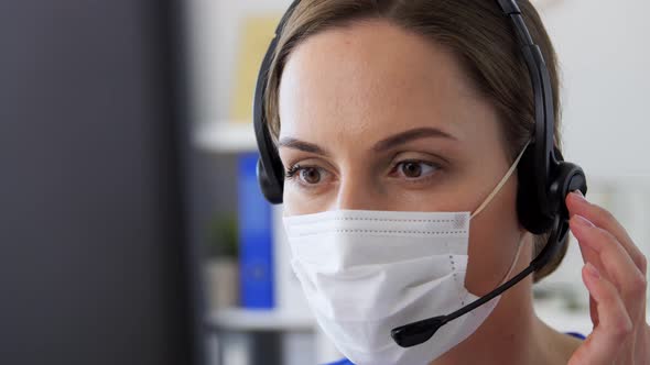 Doctor in Mask with Headset and Computer at Clinic