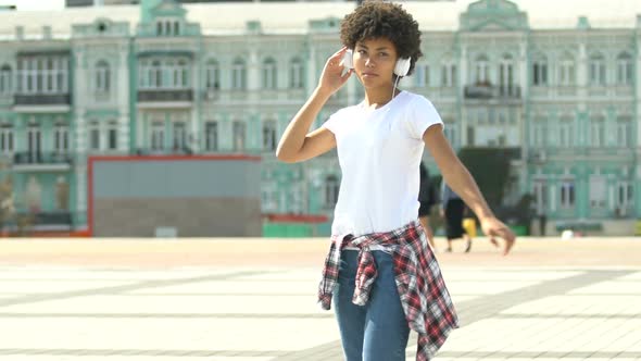 Beautiful African American Woman Moving to Music in Her Headset, Radio App