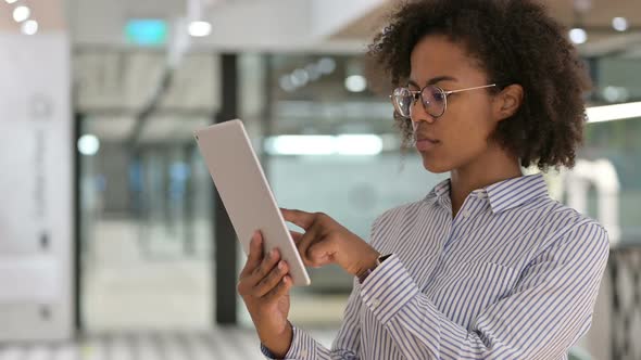 Serious African Businesswoman Using Digital Tablet