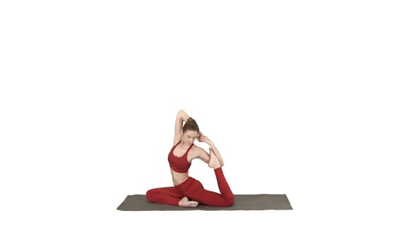 Beautiful young woman wearing red sportswear doing yoga