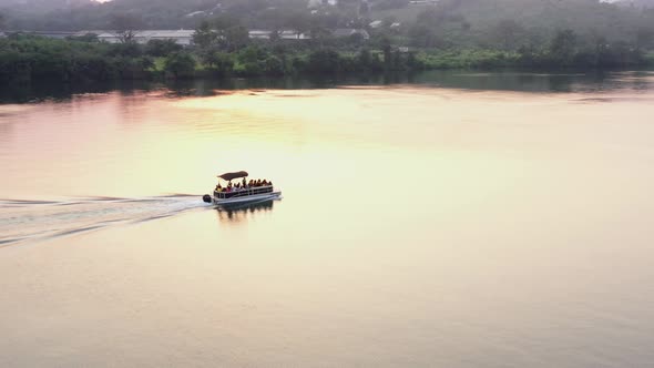 sunset with cruise boat with people on river_5