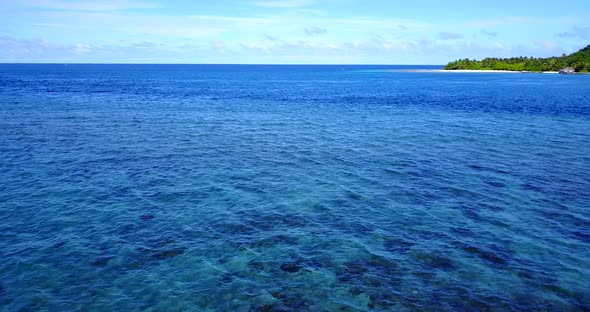 Daytime overhead abstract view of a white sand paradise beach and aqua blue ocean background 