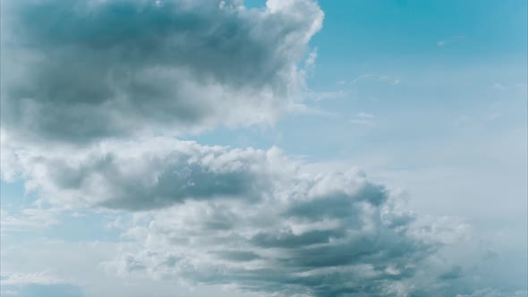 Blue Summer Sky with Thick Thunderstorm Clouds Moving Across