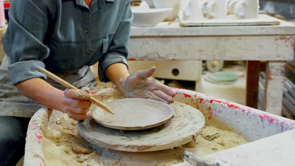 Mid section of female potter molding plate with hand tool 