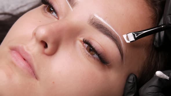 Master Applies White Markings to Correct Shape of Eyebrows with a Special Brush