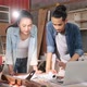 Young Asian couple carpenters man and woman discussing about design of products on laptop. - VideoHive Item for Sale