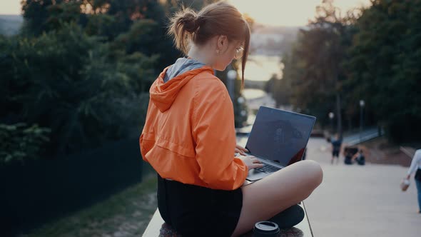 An Ambitious Student Types Her College Paper on Her Laptop