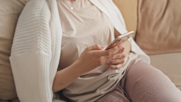 Cropped Woman Using Smartphone alt