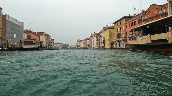 Unique low angle water surface pov of Venice seen from ferry boat navigating backwards, Venice in It