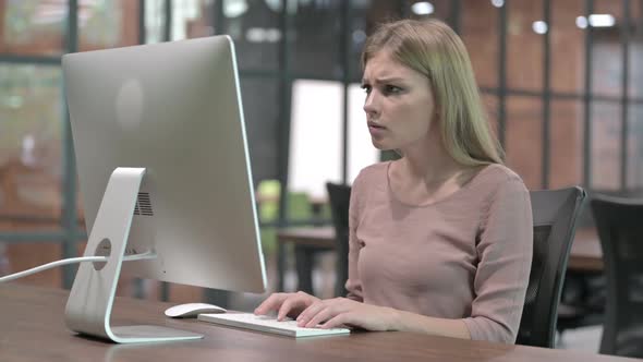 Focus Woman Getting Upset While Working on Computer