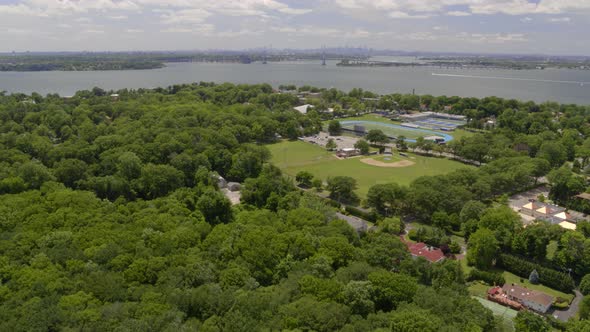 Aerial of a Village by the Water in Long Island and New York Skyline from Afar